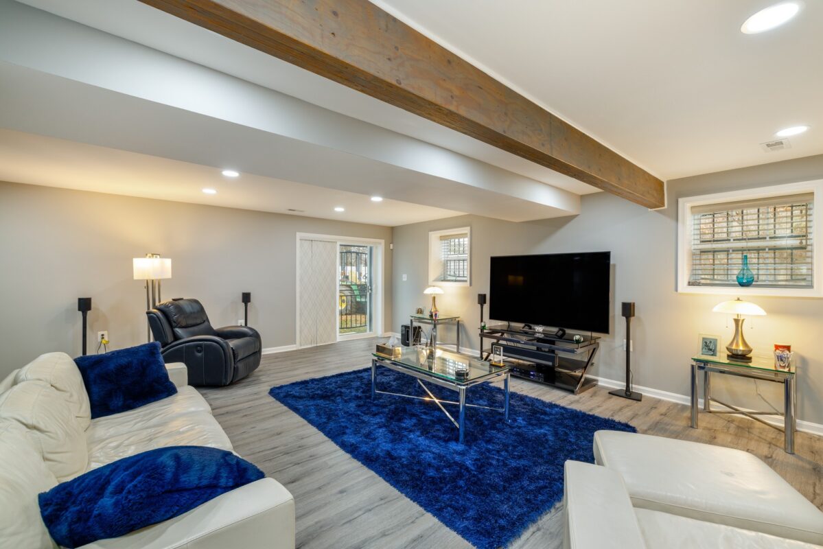Walkout Basement Sliding Glass Door - Open-Concept Lower-Level Living & Custom Media Suite by Sam's Remodeling