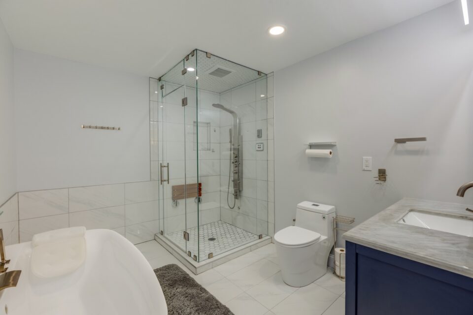Corner Glass Shower Soaking Tub Suite - Modern Primary Bath & Frameless Corner Multi-Jet Shower by Sam's Remodeling